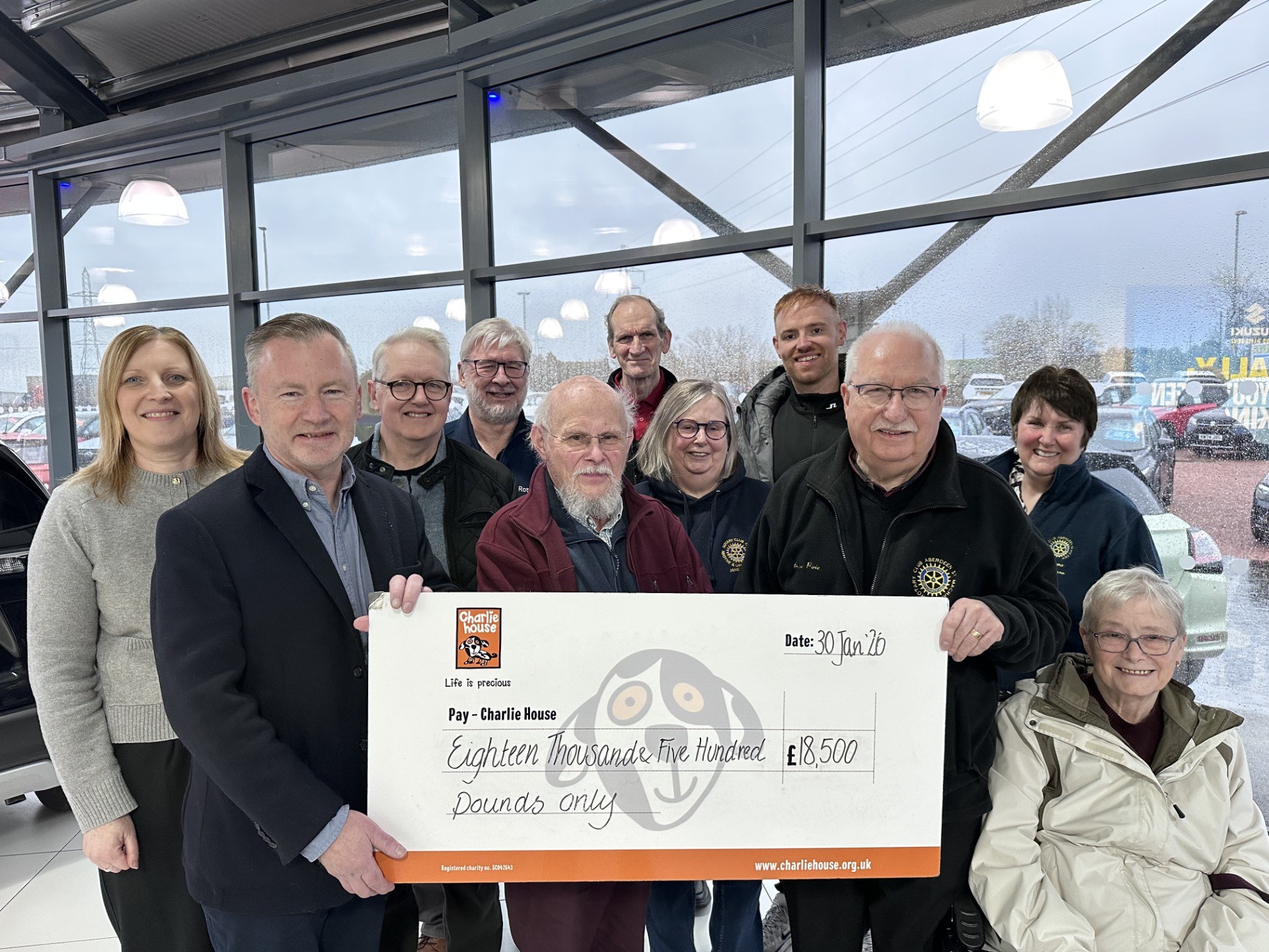 Charlie House CEO, John Brebner accepts the £18,500 donation from Alan Pirie Annual Raffle Promoter