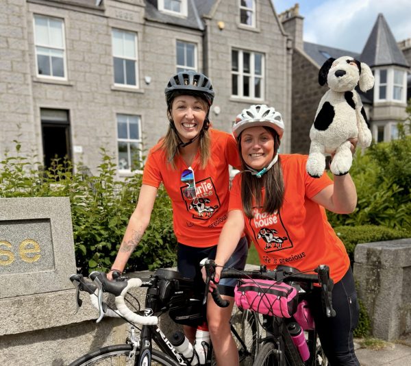 Paris Cycling Duo Sarah and Katy lift their bikes in celebration at the Eiffel Tower 2
